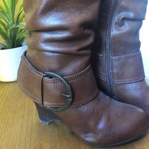 Brown wedge-heel boots.
